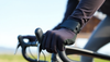 A cyclist wearing gloves gripping the handlebars