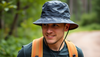 A person wearing a water repellent bucket hat outdoors