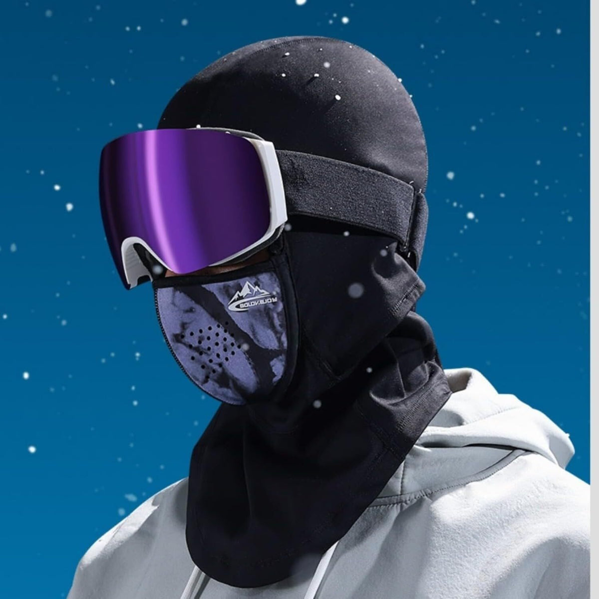 Movagear winter balaclava with magnetic mask in black worn with ski goggles under falling snow