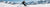 Skier enjoying skiing on snowy mountains with clear blue sky in winter landscape