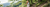 Woman hiking on forest trail wearing summer accessories including hat and backpack