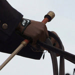 Close-up of a rider's gloved hand holding reins and a riding crop from Movagear